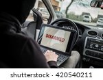 Small photo of Car Thief tries to disarm car security systems and immobiliser with laptop computer. Car thief, car theft
