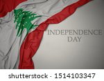 waving colorful national flag of lebanon on a gray background with text independence day. concept