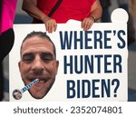 Small photo of Milwaukee, Wisconsin, USA - August 23, 2023: A supporter of former President Donald Trump holds a Hunter Biden protest sign at the entrance to the first 2024 Republican Presidential Debate.