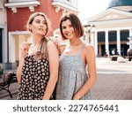 Portrait of two young beautiful smiling hipster female in trendy summer dress clothes.Sexy carefree women posing on street background. Positive models having fun, hugging 