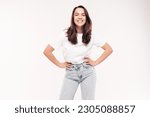 Young beautiful woman. Trendy carefree model in casual summer white T-shirt and blue jeans. Positive female isolated on white in studio. Cheerful and happy. Copy space, mockup