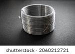 Small photo of Wire spool on a dark background.