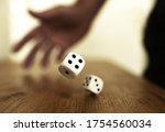 Rolling dices on a wooden table