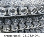 Small photo of batch of machined die cast aluminum parts placed on a rack, automotive parts mass production, CNC machining, mass production of die casting parts, aluminum die cast parts mass production