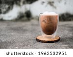 Iced Mocha coffee in double wall glass on a dirty background