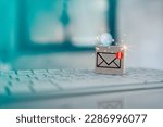 Wood cube block with envelope and notifications symbol icon for check e-mail on keyboard. Checking email. Direct marketing, online message, E-mail, electronic mail,communication concept.