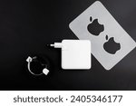 Small photo of Bangkok, Thailand - December 27, 2023 : Apple fanboy unboxing latest new MacBook Pro M3 with Apple stickers and power adapter 96 watts with black braided USB-C cable