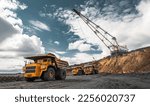 Small photo of Large quarry dump truck. Big yellow mining truck at work site. Loading coal into body truck. Production useful minerals. Mining truck mining machinery to transport coal from open-pit production