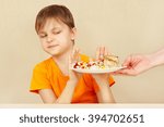 Small photo of Little disaffected boy refuses to eat a pasta with cutlet