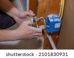 Small photo of Preparing to remove an electrical outlet of the screws for electrical wires receptacle plug panel
