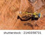 Small photo of Digger on earthworks in excavator dig the trenche at construction site on arial view of the laying sewer pipes