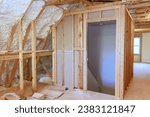 Small photo of Spray foam insulation is used to insulate wall of an under construction site new home