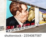 Small photo of Berlin, Germany - August 21, 2022: My God, Help Me to Survive this Deadly Love, a graffiti painting by Dmitri Vrubel at the East Side Gallery of the Berlin Wall