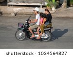 Small photo of PHNOM PENH, CAMBODIA - JANUARY 2015: On the streets Cambodian stolicy easier to move around on the bike.