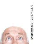 Small photo of Overwhelming admiration. Agreeable grandfather holding his head and looking up while standing isolated on white background