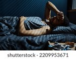 Small photo of Young man in trouble staying up all night unable to get asleep while remembering traumatic event which caused PTSD