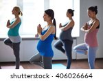 Pregnant women exercising in yoga class
