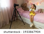 a little girl has her own video ... | Shutterstock . vector #1933867904