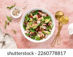 Salmon salad bowl with fresh radish, cucumber, red onion and green mixed leafy vegetables. Healthy diet food, lunch menu. Top view