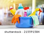 Basket with cleaning items on blurry background