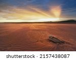 Sunset, Beams in the sky of Khakassia Oglakhty mountains. reservoir without water, sandy ripples, clay and hills, rainy sky over Mount Tepsey Tepsei