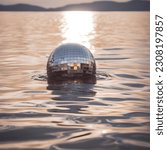 Small photo of Disco ball floating in the sea. Rave Party