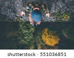 Man Traveler sitting on cliff bridge edge with forest aerial view Travel Lifestyle adventure vacations concept 