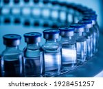 Small photo of Group of Vaccine bottles. Medicine in ampoules. Glass vials for liquid samples in laboratory.