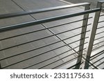 modern building balustrade, detail in polished and satin steel, the parapet protects from falling. Contemporary architecture. handrail geometry.