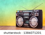 Small photo of Retro boombox ghetto blaster outdated portable radio receiver with cassette recorder from 80s front gradient colored wall background. Rap, Hip Hop, R&B music concept. Vintage old style filtered photo