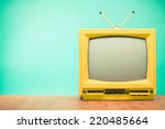 Retro old yellow TV front turquoise wall background