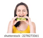 Hungry woman eating sandwich. Student girl holding fast food, isolated on white background. Studio shot