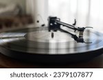 Vinyl record with music on retro dj turntable player. Turntables needle on analog disc with hip hop music. Listen to the musical tracks in hi fi quality with vintage turn table device