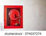 Fire hoses packed inside of red emergency box at the wall