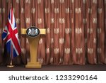Podium speaker tribune with flags of Great Britain and UK coat of arms. Briefing or press conference of prime minister or queen of UK  Great Britain. 3d illustration