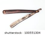 Small photo of Antique Straight Razor. Close up isolation of a vintage straight razor from 1800 or thereabout with wooden handle & crudely formed blade.