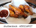 Small photo of Fried chicken. A Buffalo wing is an unbranded chicken wing section (flat or drumbeat) that is generally deep fried then coated in a sauce consisting of a vinegar based cayenne pepper hot sauce.