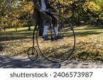 Small photo of Penny farthing bicycle. High wheeler bicycle in park