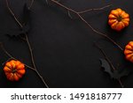 Modern Halloween background with pumpkins, bats, decorations. Halloween party invitation card mockup. Flat lay, top view, copy space.