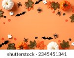 Happy Halloween holiday concept. Halloween decorations, pumpkins, bats, ghosts, spiders, maple leaves on orange background. Halloween party invitation card mockup. Flat lay, top view
