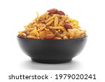 Close-Up of Spicy Chatpata Mixture in a black Ceramic bowl made with peanuts, corn flakes. Indian spicy snacks (Namkeen)