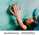 Young Woman Climbing Up On Wall ...