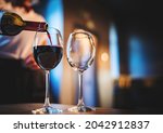 Waiter Pouring Red Wine Into A...