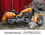 Small photo of Fairfield, CA - September 3, 2022: Orange Jelly Belly Victory kingpin motorcycle on display at the museum.