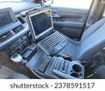 Small photo of Los Angeles, CA - October 5, 2023: Inside of a Police car with built in computer and other custom built gadgets around.