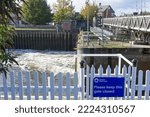 Small photo of Water flows from the lock gates under the Sluice bridge on the river Witham. Boston Lincs. UK. Oct. 2022