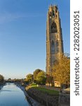 Small photo of St. Botolph's stump church tower with the River Witham Sluice bridge in the distance on a sunny autumn afternoon