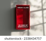An empty red emergency box with an in case of emergency breakable glass on the front mounted on a wall - 3D render