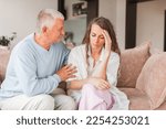 Small photo of Worried aged father embracing comforting grown up daughter with broken heart family sit on sofa, elderly dad soothe crying adult child, divorce or miscarriage, share problem with someone close concept