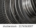 Short and long metal blades of high-speed steam turbine in workshop of industrial equipment production plant extreme closeup